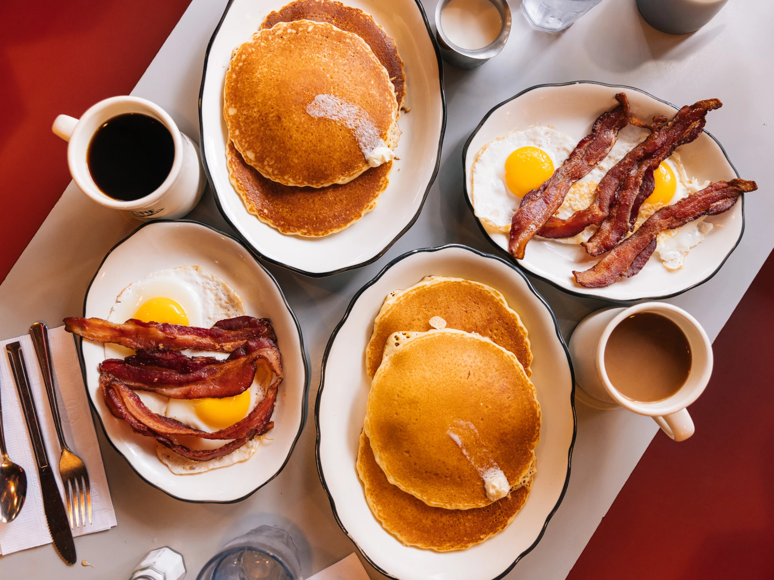 Table spread of pancakes, eggs and coffee